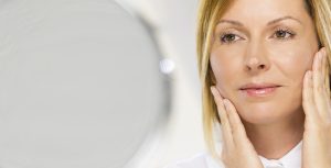 Middle aged woman enjoys the rejuvenated appearance of her eyes.