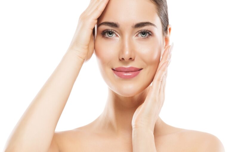 Beautiful woman in her 40s smiles during a facelift consultation with her plastic surgeon