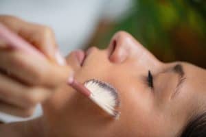 Woman closes her eyes during a TCA chemical peel to treat sun damage