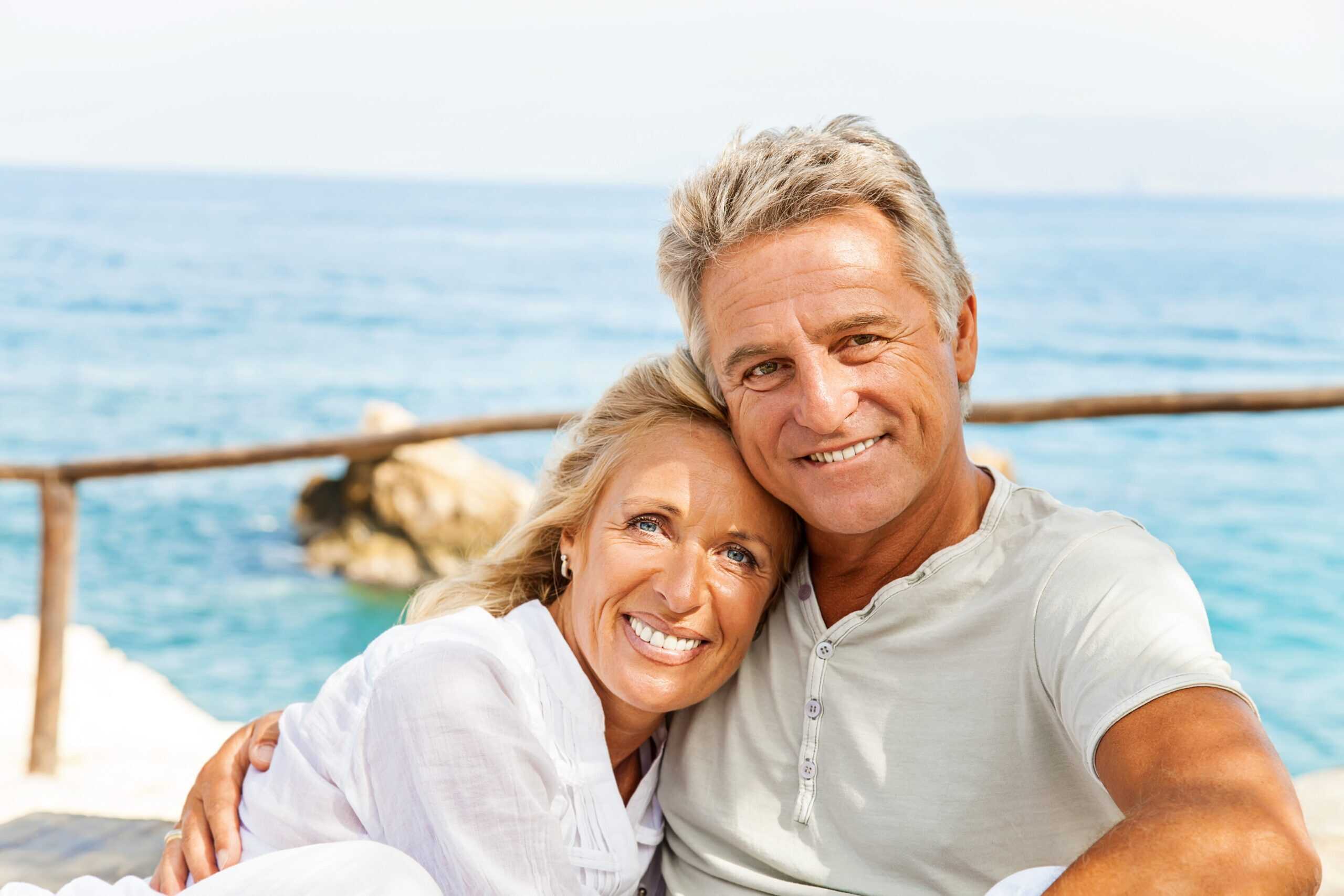 Mature couple smiling on a boat, enjoying the sights without cataracts interfering with vision