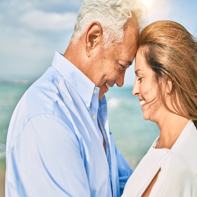 Mature Hispanic couple embraces, pleased with their renewed sex life after O-shot injection