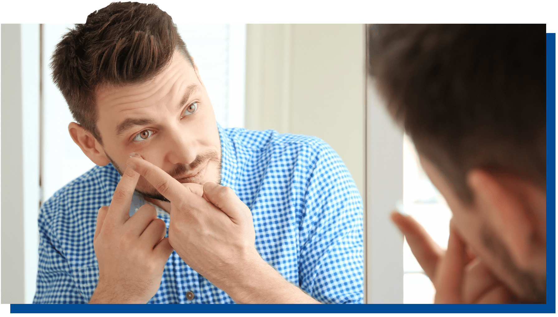Young man putting in contacts