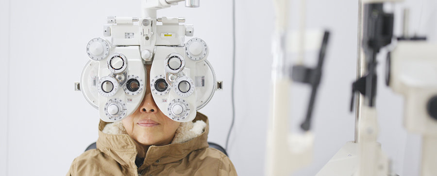 Older woman taking eye exam vision test